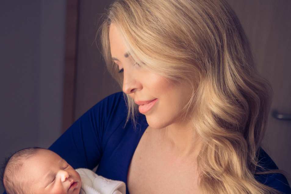Woman Holds Sleeping Newborn