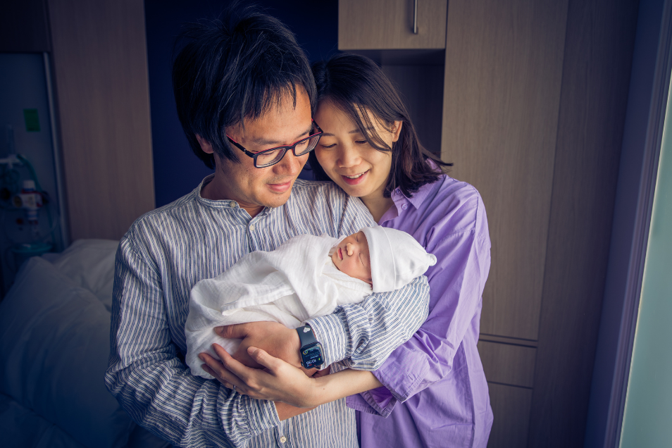 Couple Cradles Their Baby