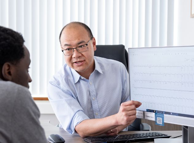 Dr Ng With Patient Looking At Heart Rhythm On Computer