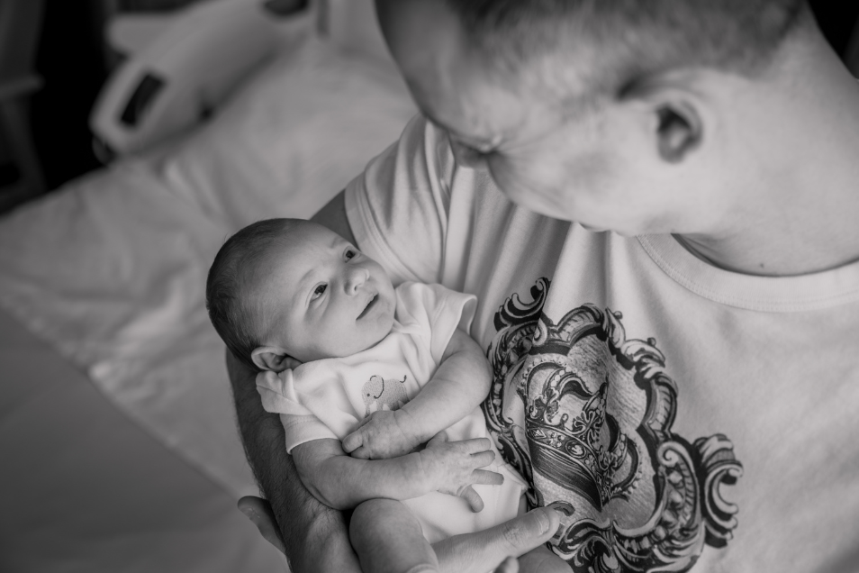 Father Holds Baby In His Arms