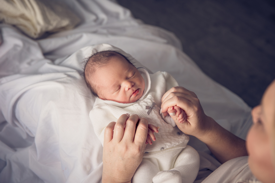 Mother Holds Baby Hands
