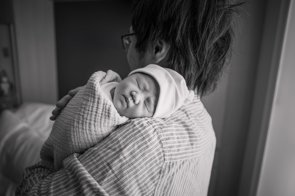 Father Holds Baby On His Shoulder